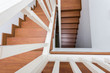 © sutichak - wooden staircase made from laminate wood in white modern house