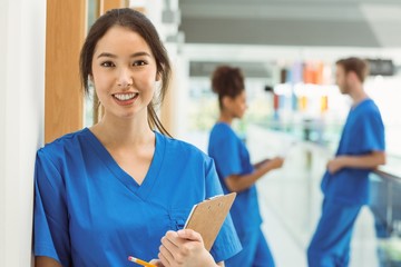 Wall Mural - medical student smiling at camera in hallway