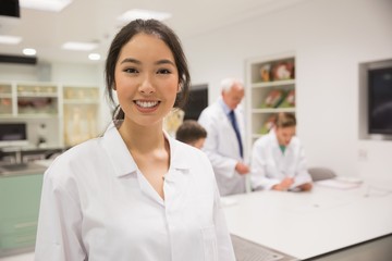 Wall Mural - pretty science student smiling at camera