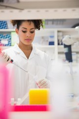 Wall Mural - pretty science student using pipette