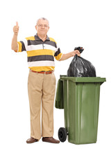 Canvas Print - Senior giving a thumb up by a trash can