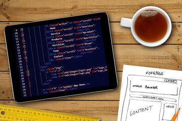 Wall Mural - website wireframe sketch and programming code on digital tablet