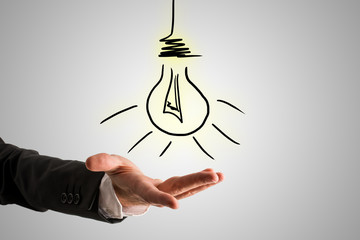 Wall Mural - Conceptual Bulb Drawing Over Businessman Hand