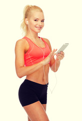 Wall Mural - smiling sporty woman with smartphone and earphones