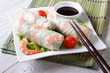 spring roll with shrimp and sauce on a plate. horizontal