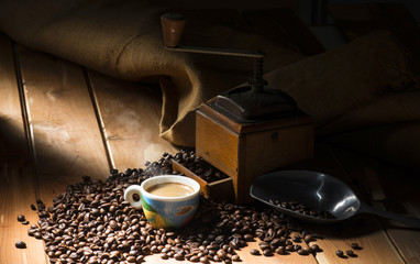 Wall Mural - cup of coffee on the wooden table