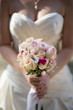 Bride holding wedding bouquet of roses