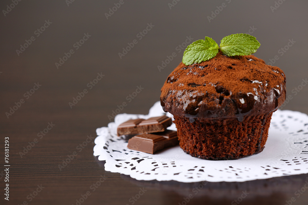 Yummy chocolate cupcake on table