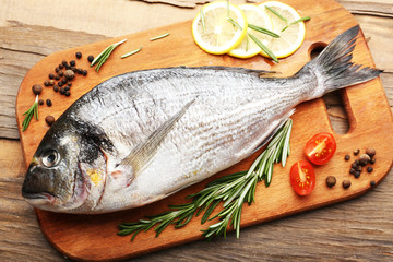 Poster - Fresh raw fish and food ingredients on table