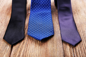 Trendy ties on wooden planks background