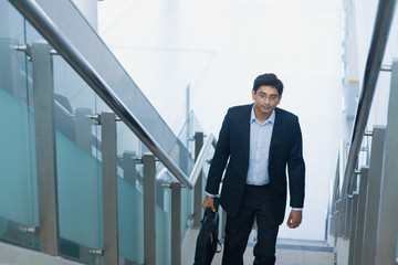 Wall Mural - Asian Indian businessman ascending steps