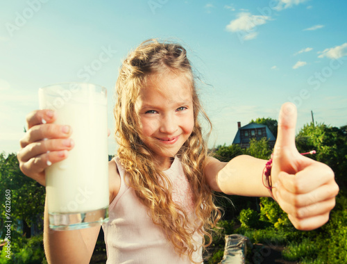 Fototapeta na wymiar Girl holding glass with milk