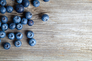 Wall Mural - Fresh Blueberries on wooden Background