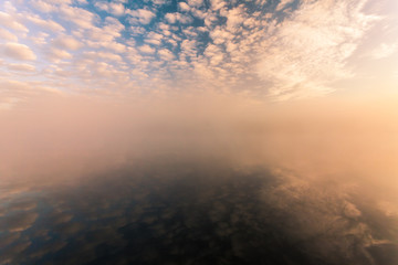  misty morning on the river and clouds reflected in water