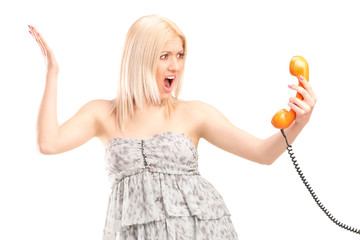 Poster - Angry woman holding a telephone speaker