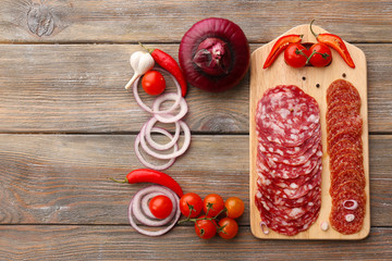 Wall Mural - Sliced salami with chili pepper, cherry tomatoes, onion and