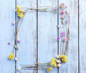 Wall Mural - Dried flowers on color wooden background