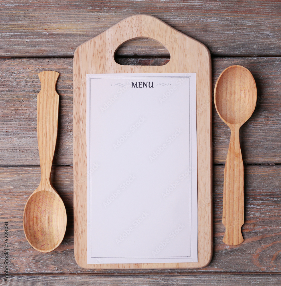 Menu sheet of paper on rustic wooden surface background