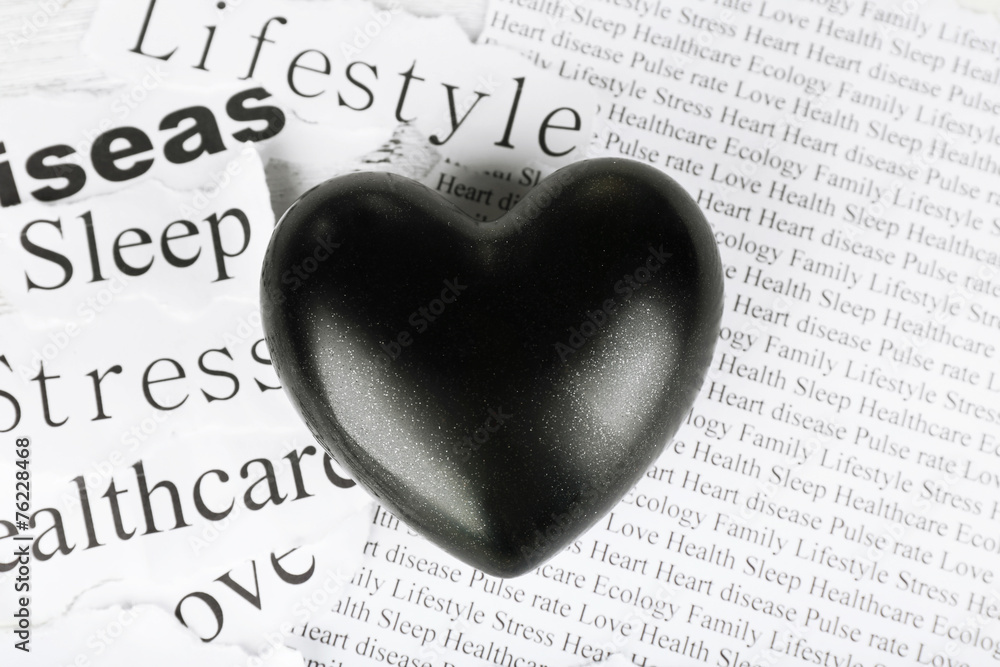 Decorative heart on paper notes, on wooden background