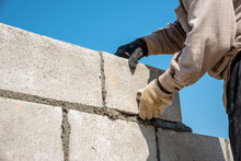 Worker Build Concrete Wall By Cement Block And Plaster 