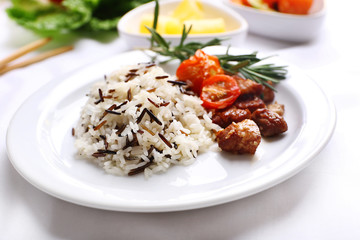 Canvas Print - Tasty rice with meat served on table, close-up