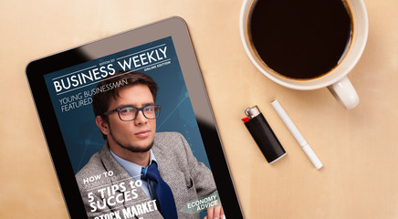 Wall Mural - tablet pc showing magazine on screen with a cup of coffee on a d