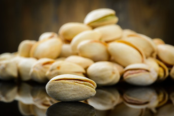 Pistachios on wooden table. Selective focus