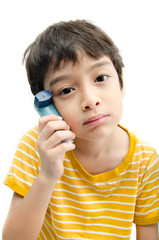 Little boy using Asthma inhaler for breathing on white backgroun