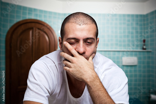 Fotografie, Obraz Tired man looking in the mirror in the morning