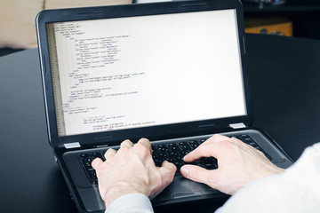 Wall Mural - website development process - programmer writing code