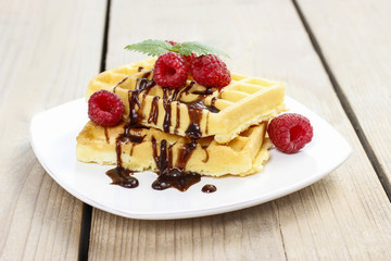 Wall Mural - Waffles with chocolate and raspberries