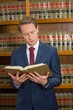 © WavebreakMediaMicro - Lawyer reading in the law library