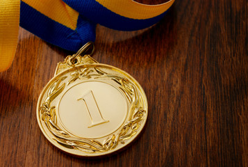 Gold medal on a wooden table