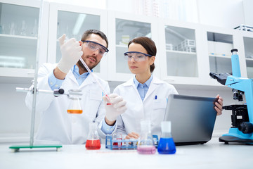 Canvas Print - young scientists making test or research in lab