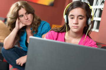 computer addicted girl ignores her worried mother