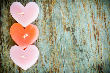 Wall Mural - Candle heart shape on wood table in vintage style