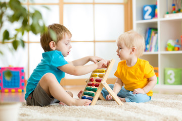 children boys playing with abacus