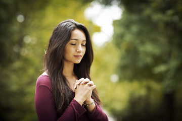 Wall Mural - Woman praying outdoors