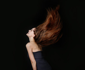 Beautiful dancing young woman with flowing long hair