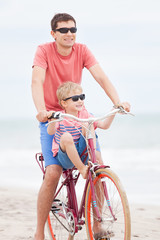 Wall Mural - family biking at the beach