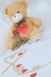 Teddy bear with red heart and red rose