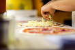 © alexstreinu - Closeup of chef baker in white uniform making pizza at kitchen