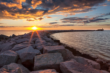 Wall Mural - Sunset over breakwater