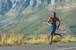 © softfocusphoto - Athletic,  black male running along a road