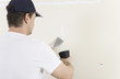© pfluegler photo - Mann renoviert Wand