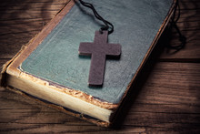 Closeup Of Wooden Christian Cross On Bible