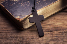Closeup Of Wooden Christian Cross On Bible