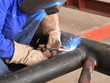 welder is welding pipe structure with all safety