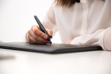  Closeup image  of female hands working on graphic tablet