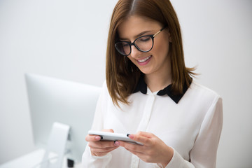 Wall Mural - Portrait of beautiful businesswoman using smartphone